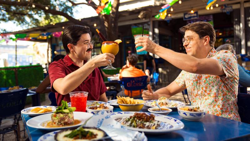 Couple enjoying frozen margaritas and mexican Food