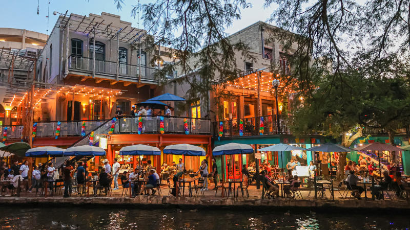 People dining along the San Antonio River Walk.