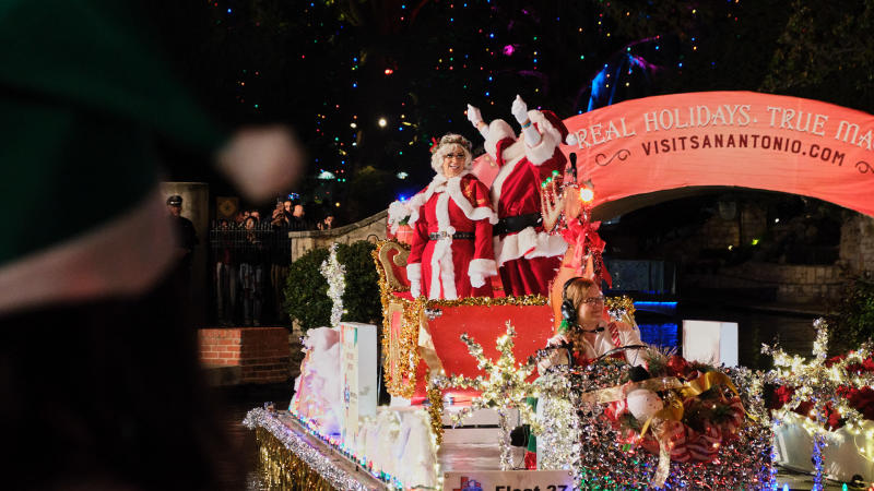 Santa and Mrs. Claus on parade float at Ford Holiday River Parade on the River Walk.