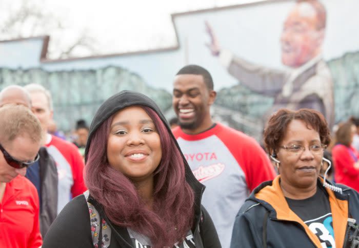 Woman in hoodie in front of MLK Mural in San Antonio at Annual MLK March.