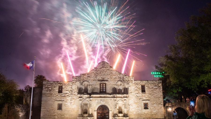 Fireworks going off behind the Alamo.