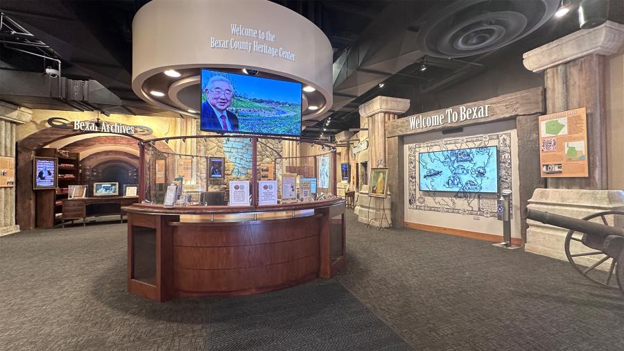Lobby of Bexar County Heritage Center with exhibits and screens.