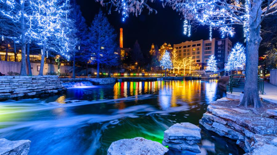 Museum Reach portion of River Walk lit up with holiday lights.
