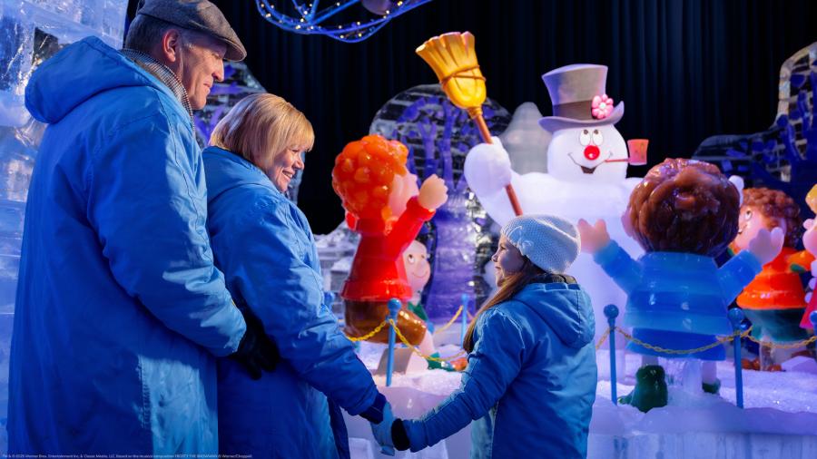 Families looking at Frosty the Snowman exhibit.