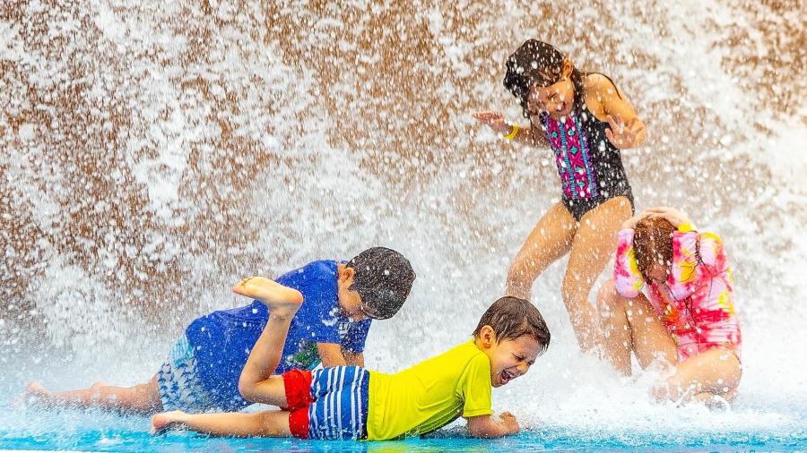 Kids getting splashed by water at Water Park