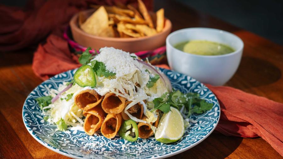 Plate of flautas topped with jalepenos and lime from Mexico Ceaty in San Antonio.
