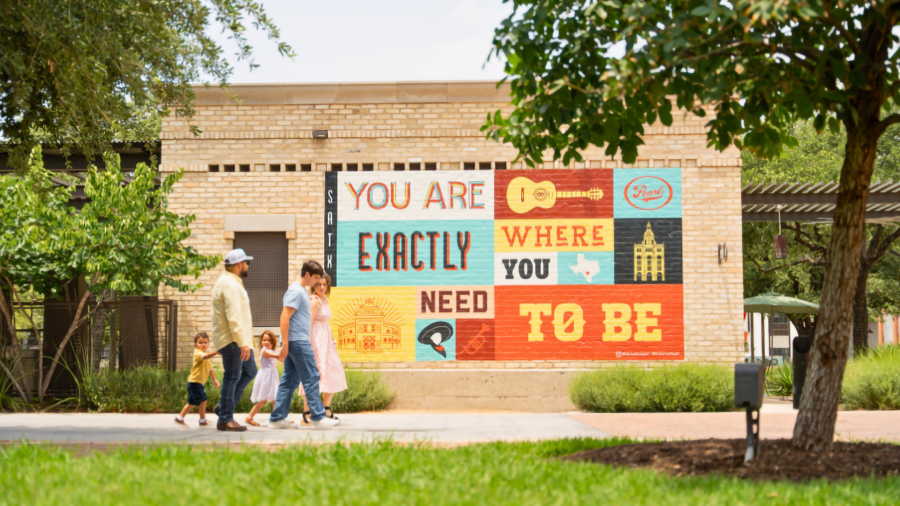 Family walking by the Exactly Where You Need to Be Mural at the Pearl