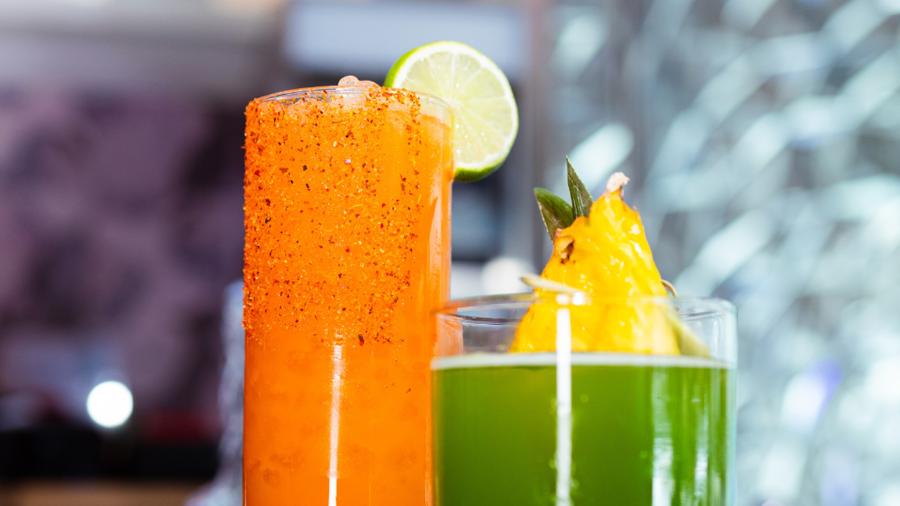 Two tropical cocktails side-by-side.