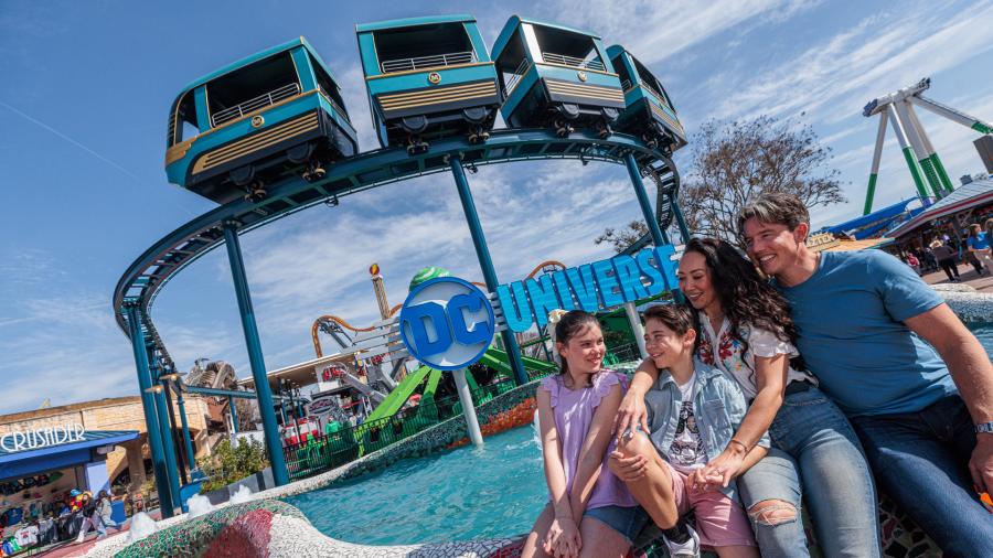 Family hugging in front of ride.