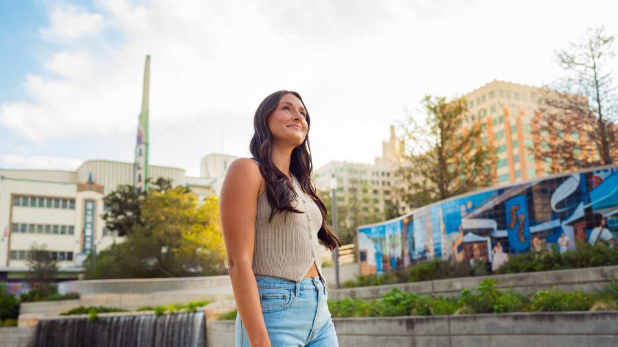 Woman admiring outdoors in front of mural at San Pedro Culture Creek.