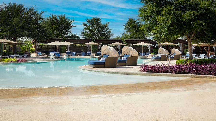 sandy poolside with cabanas