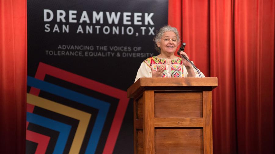 Woman speaking at podium at DreamWeek San Antonio.