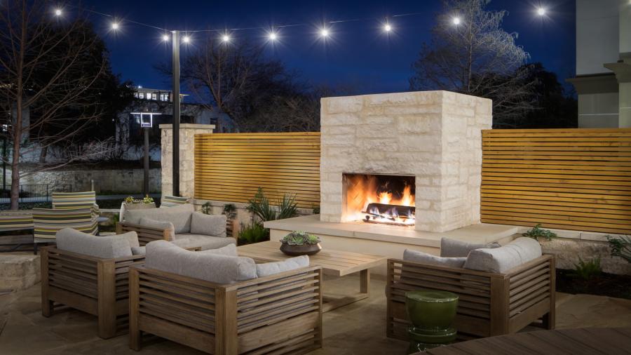 outdoor patio with a fireplace and seating