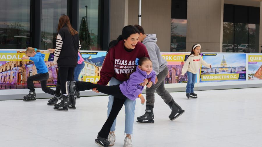 Mother at daughter ice skating at ice rink at The Rock at La Cantera in San Antonio.