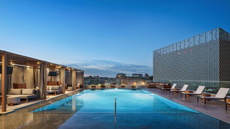 Pool lit up at night at Thompson San Antonio.