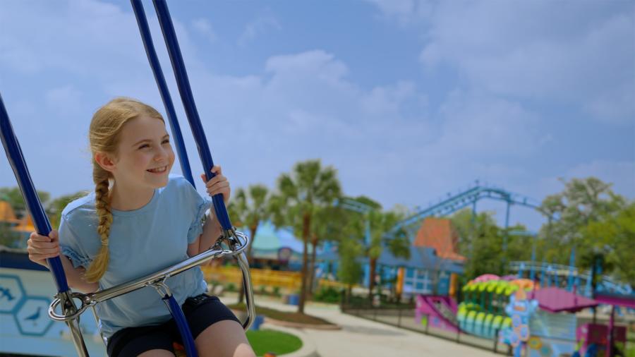 Girl on a swing at SeaWorld San Antonio.