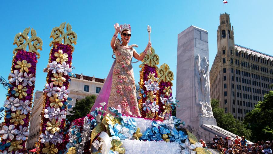 Parade in downtown San Antonio with woman on float waving
