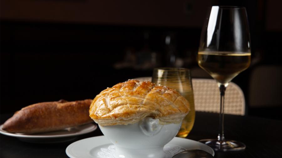 Bowl next to bread and wine glass
