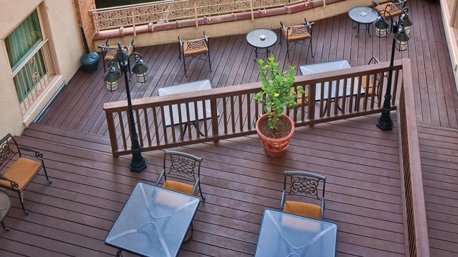 Bird's eye view of hotel patio with tables and chairs.