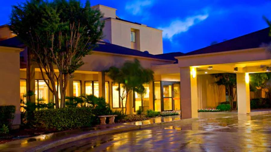 Exterior view of hotel with windows lit up at night.