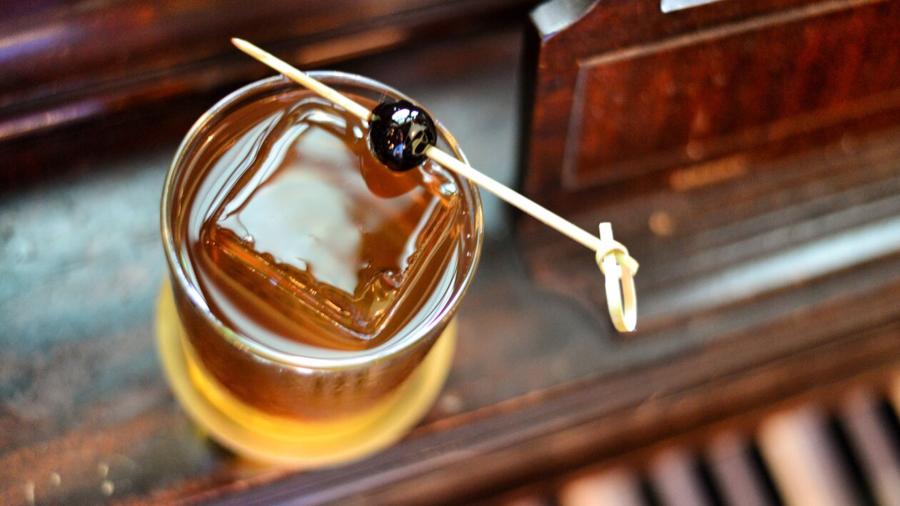 Overhead view of old fashioned with square ice cube
