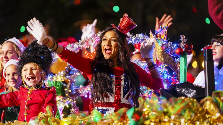Participants waving from river barge with holiday decorations
