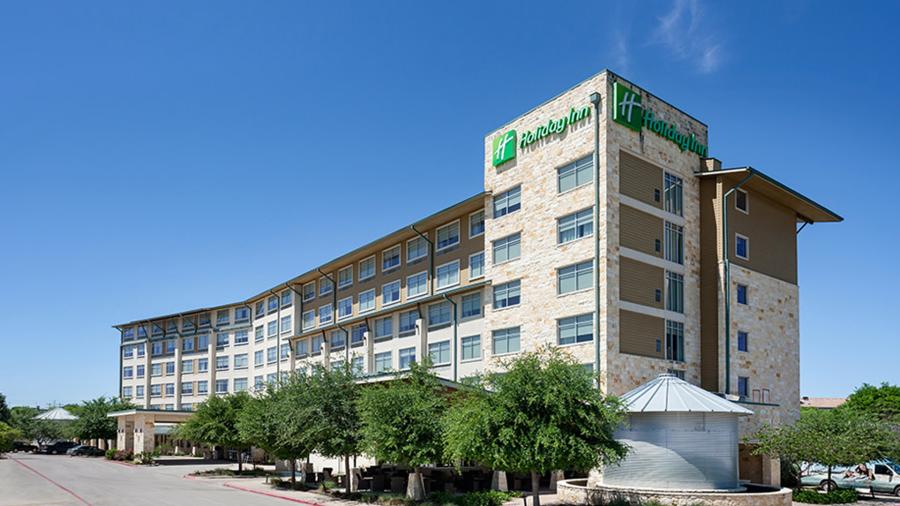 Exterior view of Holiday Inn Northwest / SeaWorld building with clear skies.