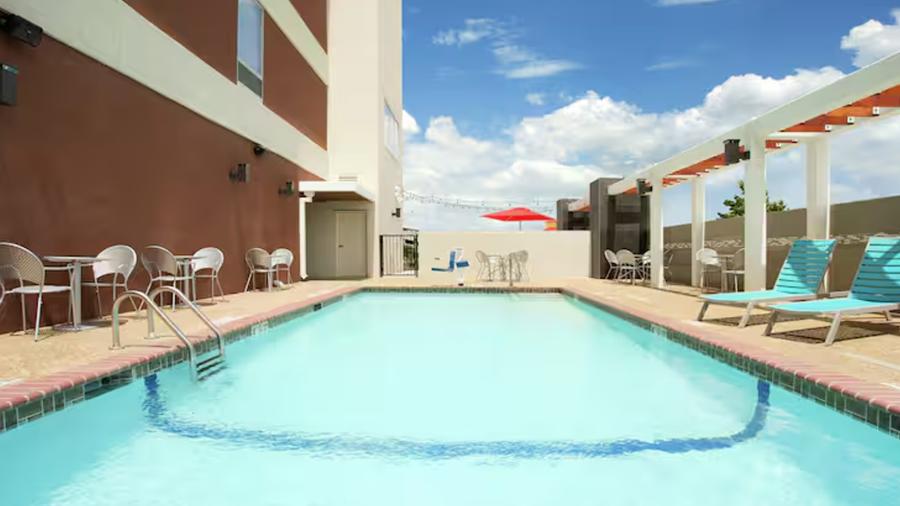 Outdoor hotel pool with lounge seating.