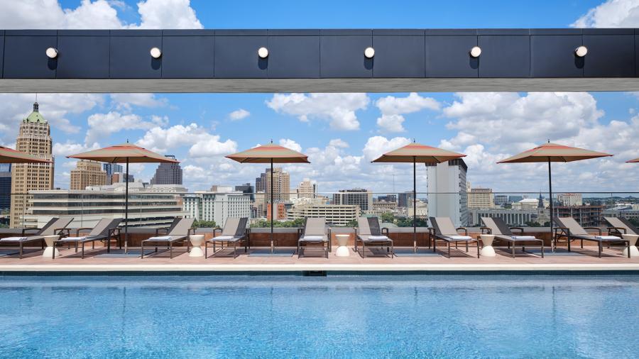 Hotel pool with lounge chairs and umbrellas