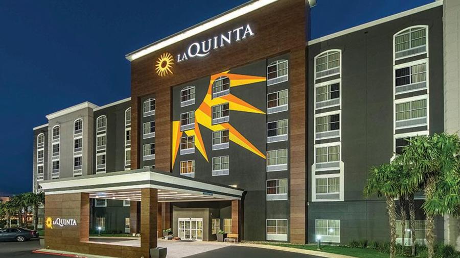 Exterior view of the hotel building with sun rays painted on it.