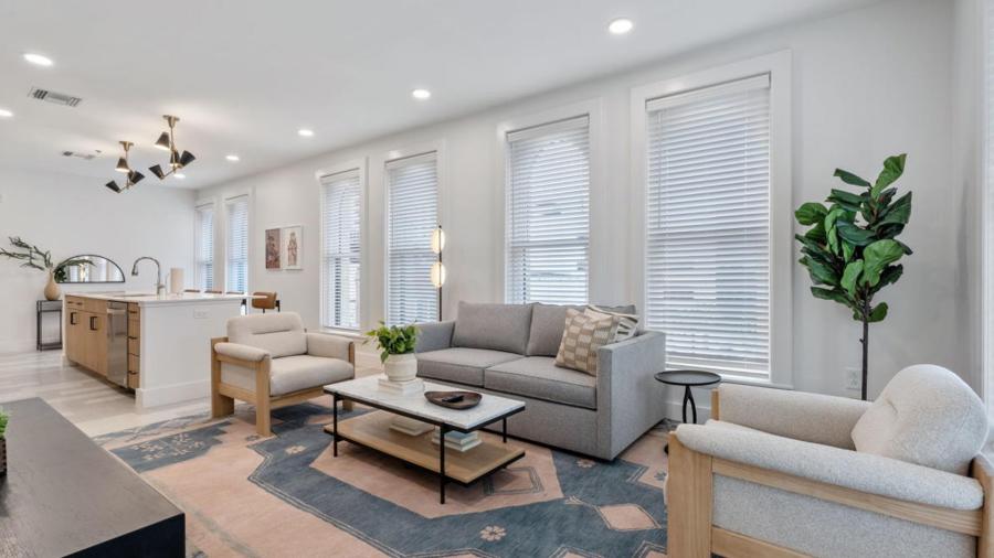 Living room with gray sofa and white accent chairs.