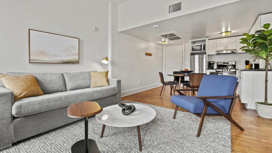Living room with blue accent chair and gray sofa.