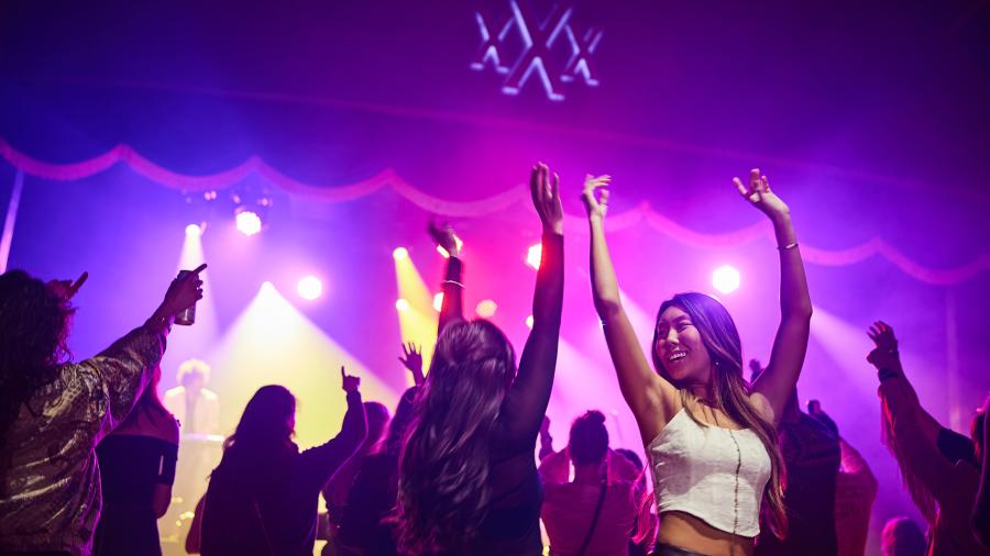 Two girls dancing with their arms up