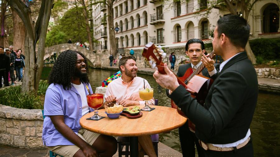 Two mariachi members serenaded two men