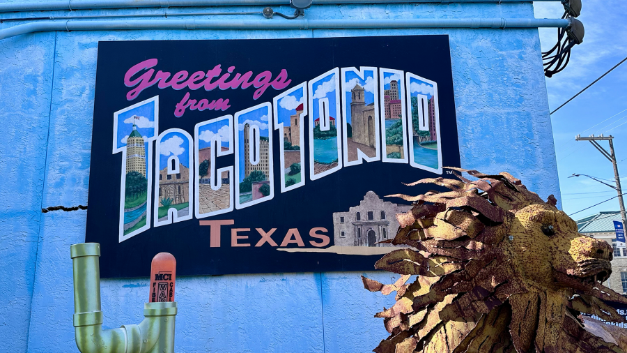 colorful mural of postcard that reads "Greetings from Tacotonio, Texas"