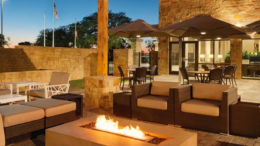 Luxury outdoor hotel patio with fireplace