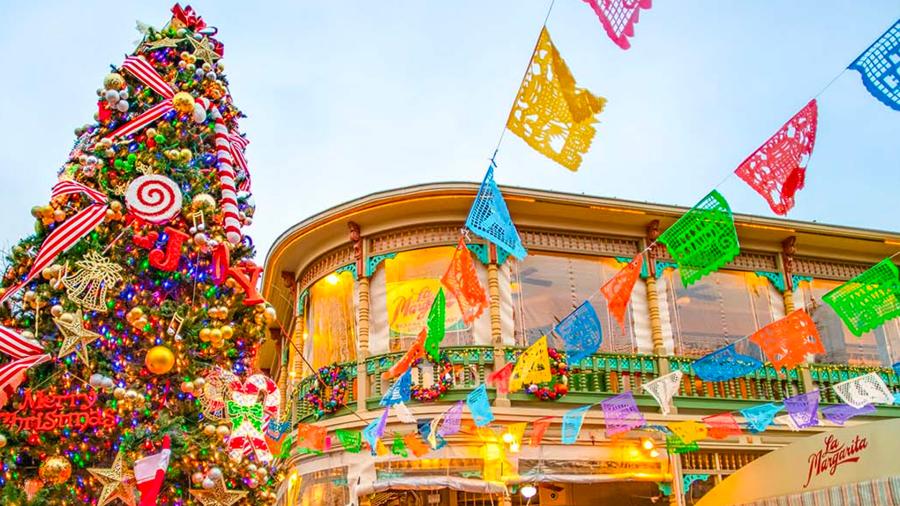 Christmas tree next to colorful papel picado at Historic Market Square.