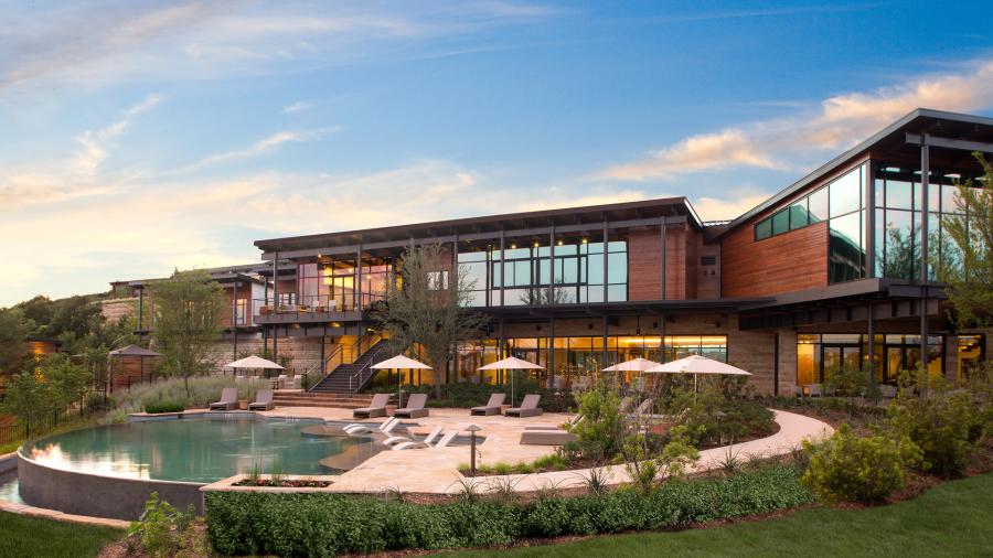 External building overlooking pool with umbrellas