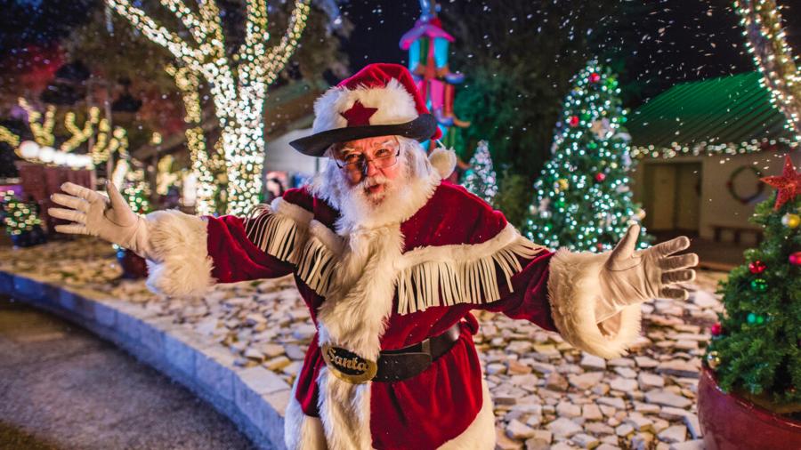 santa in front of holiday outdoor decorations