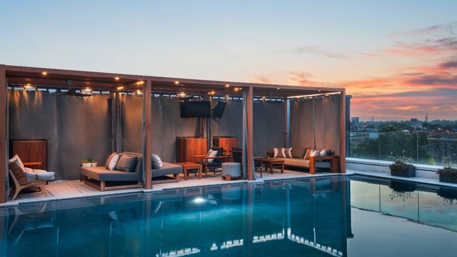 Pool deck at hotel with sunset in distance