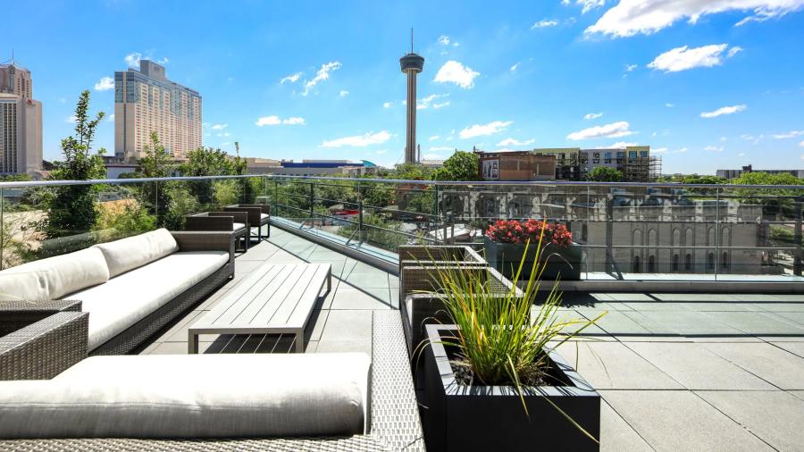 Rooftop view of Fairmont Hotel with Tower of the Americas in distance.