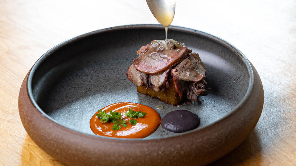 Spoon drizzling glaze over meal.