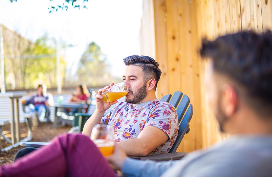 man drinking beer with friend