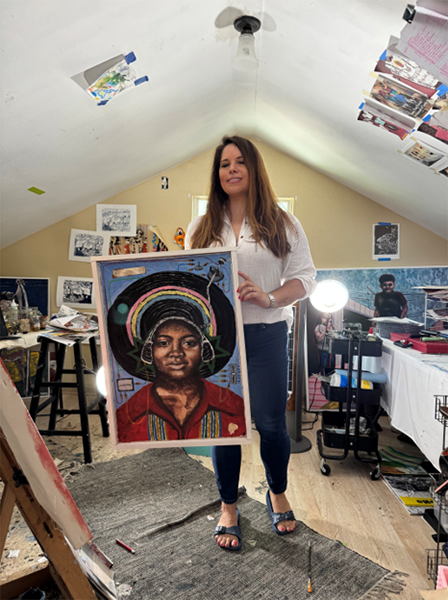 Artist Kristina Salinas posing with art