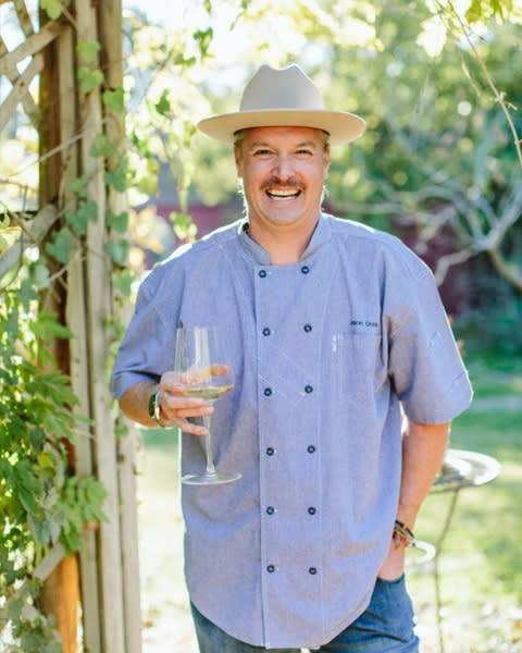 Chef Jason Dady holding wine glass