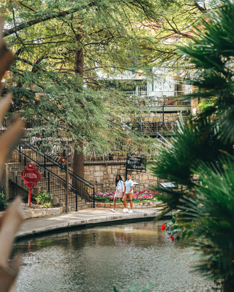 Two people walking on River Walk