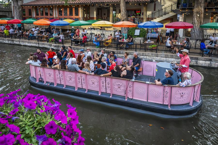 pink barge floating on San Antonio River Walk