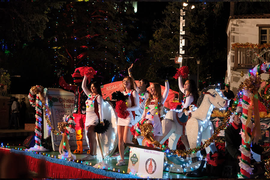 Group of people waving on holiday themed float