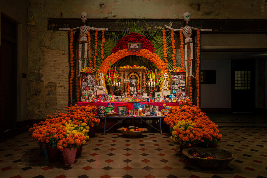 Day of the Dead Altar with many marigolds and photos on display at Hotel Emma.