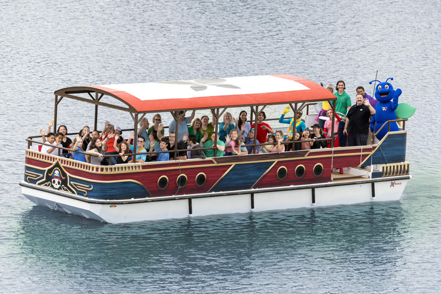 Group of people on covered boat waving